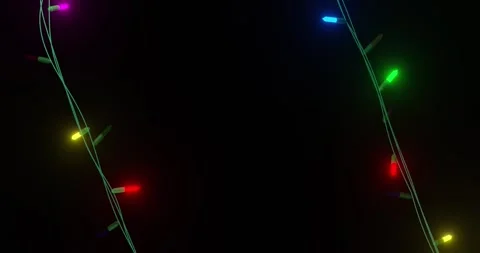 Coloured christmas string lights flashing on black background, copy space Stock Footage 253158481