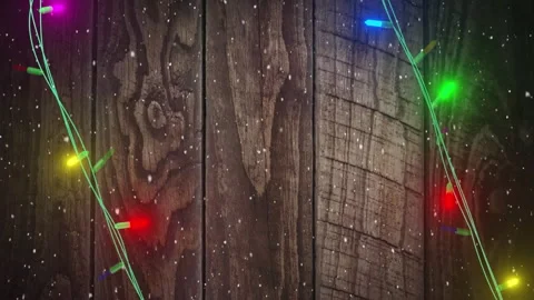 Coloured christmas string lights flashing over wooden boards background, copy Stock Footage 310924854