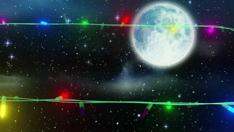 Coloured christmas string lights flashing over full moon in night sky Stock Footage 310924861