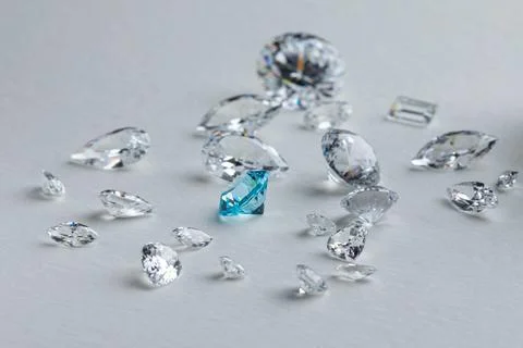Coloured diamonds of different sizes at the workplace of a diamond expert Stock Photos