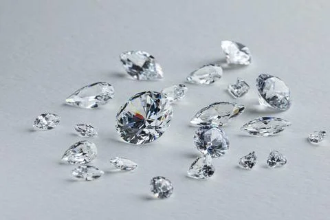 Coloured diamonds of different sizes at the workplace of a diamond expert Stock Photos