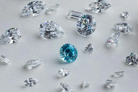 Coloured diamonds of different sizes at the workplace of a diamond expert Stock Photos
