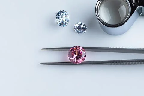 Coloured diamonds of different sizes at the workplace of a diamond expert Stock Photos