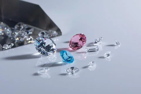 Coloured diamonds of different sizes at the workplace of a diamond expert Stock Photos
