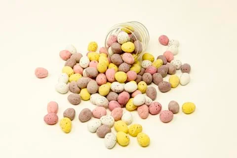 Coloured easter eggs and glass cup Stock Photos