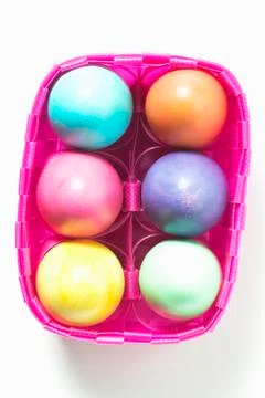 Coloured Easter eggs in basket Stock Photos