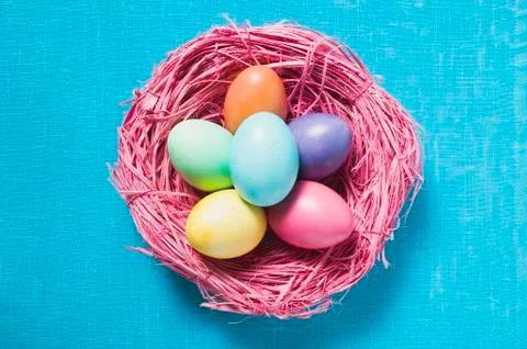 Coloured Easter eggs in Easter nest (overhead view) Stock Photos