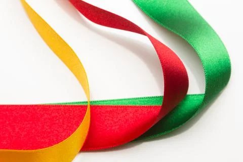 Coloured fabrics and ribbons; basic colours on a white background Stock Photos