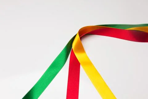 Coloured fabrics and ribbons; basic colours on a white background Stock Photos