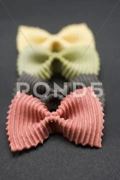 Coloured farfalle in a row Stock Photos