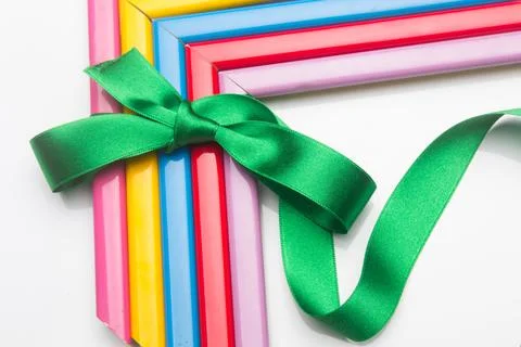 Coloured frames and a gift ribbon Stock Photos