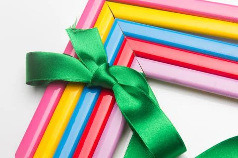 Coloured frames and a gift ribbon Stock Photos