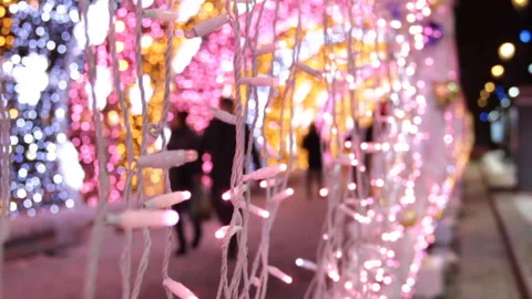 Coloured light bulbs and led snowflakes in light tunnel. Video stock 120450997