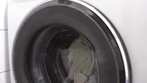 Coloured linen is washed in the washing machine. Stock Footage 297738773