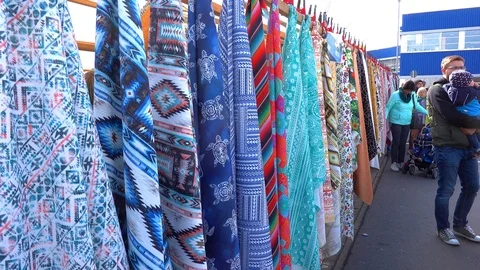 Coloured, multi-patterned cloths and fabrics hanging on a leash 動画素材 105114915