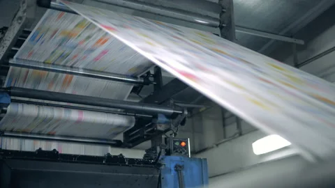 Coloured paper page is moving through the typographic press. Printing newspapers Video stock 111365997