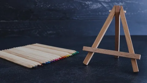 Coloured pencil lined up and hand adding blank canvas Stock Footage 116646466