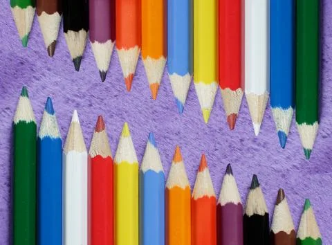 Coloured pencils on violet background Stock Photos