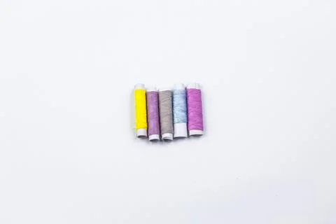 Coloured sewing threads on white background. Stock Photos