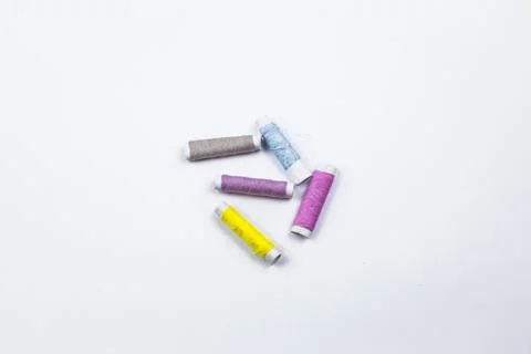 Coloured sewing threads on white background. Stock Photos