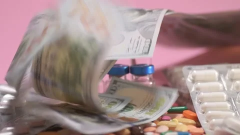 Coloured tablets and pills falling down on pink background 스톡 동영상 168172645