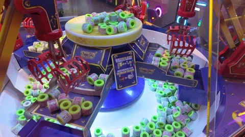 Colourful arcade claw machine with neon lights and prize in playful display Stock-Footage 318133183