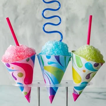 Colourful assorted snow cones against a light background. Stock Photos