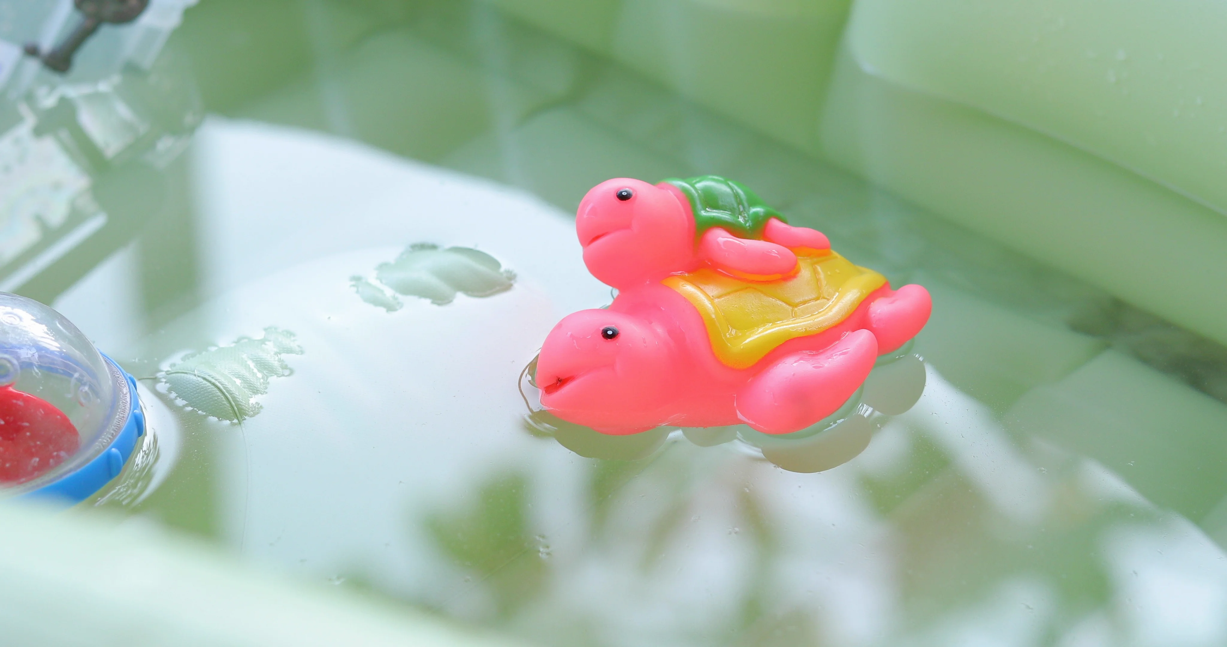 colourful baby toy floating on water in ... | Stock Video | Pond5