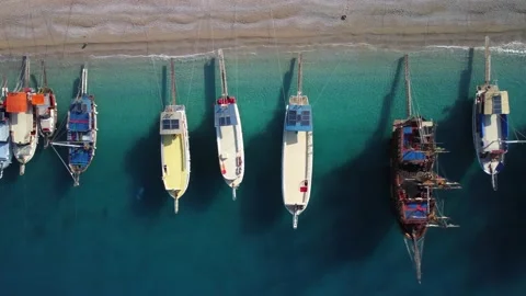Colourful boats aligned from the smallest to the biggest on the Oludeniz beac Stock Footage 193096377