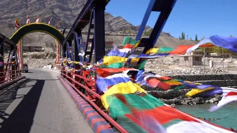 Colourful Buddhist prayer flags on a bridge at Leh Ladakh, Northern India Stock Footage 92106617