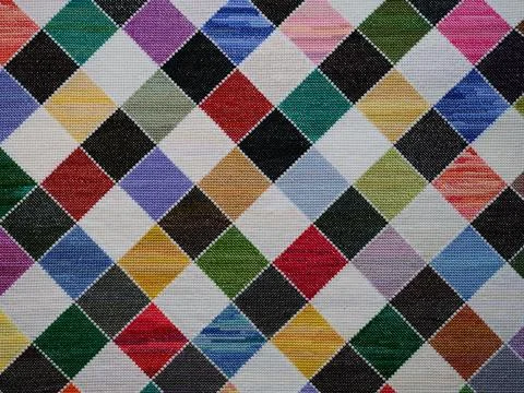 Colourful checkered pattern hand embroidered in cross-stitch background Stock Photos