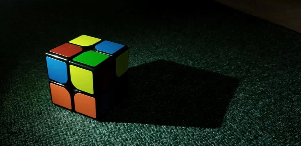Colourful cube and its shadow Stock Photos