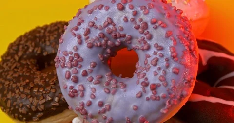 Colourful Donuts rotating Overhead view Stock Footage 122178154