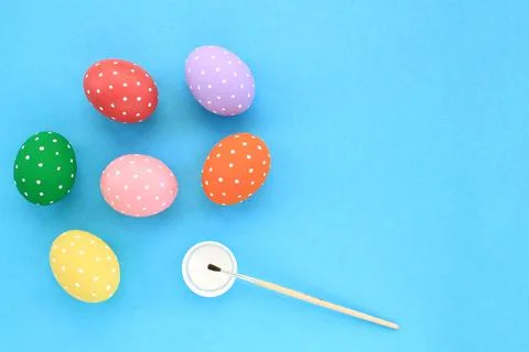 Colourful easter eggs and paintbrush with white color on blue background Stock Photos