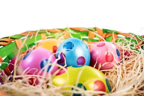 Colourful Easter eggs with polka dots in a basket Stock Photos