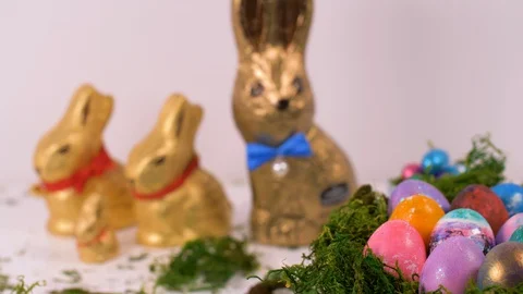 Colourful Easter Eggs Spinning with Chocolate Bunnies Background. Easter Stock Footage 129073359