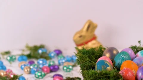 Colourful Easter Eggs Spinning with Chocolate Eggs Background Stock-Footage 129073513