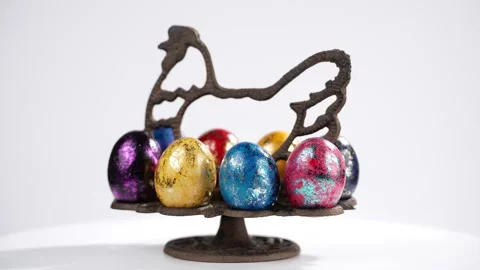 Colourful Easter eggs in a symbolized chicken as an iron stand, studio Stock Footage 334346874