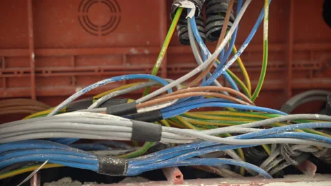 Colourful electrical cables wrapped with black insulting tape in junction box Video stock 219545187