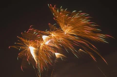 Colourful fireworks explode with colourful trails of light in the night sky, Stock Photos