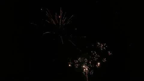 Colourful fireworks show exploding against dark night sky Video stock 143231307