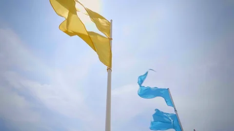 Colourful flags blowing in the wind slow motion Stock Footage 119674206