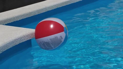 Colourful inflatable beach ball floating in shiny blue swimming pool Stock Footage 228796757