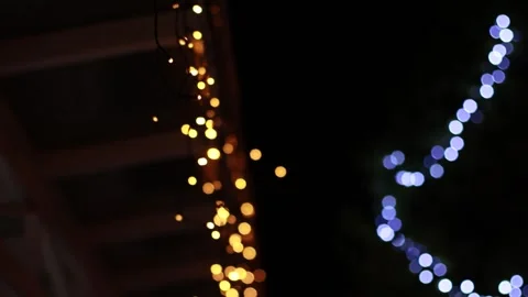 Colourful Lights Hanging from Tree and Roof at Night Video stock 241322921