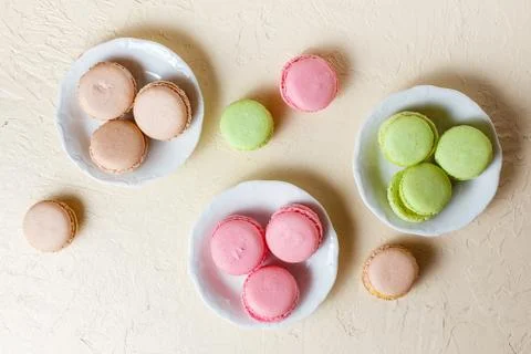 Colourful macaroons on the plates Stock Photos