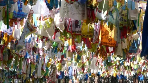 Colourful multi-coloured Buddhist prayer flags sway in the gentle breeze. Stock Footage 284047574
