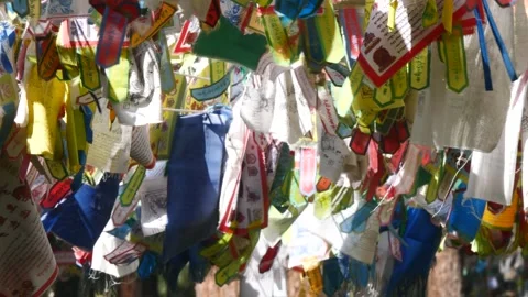 Colourful multi-coloured Buddhist prayer banners sway in the gentle breeze. Stock Footage 284047578