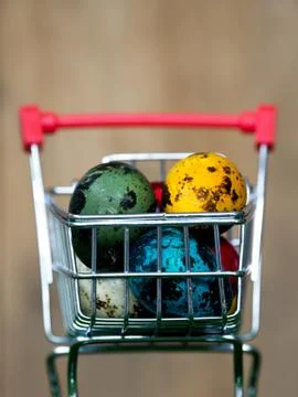 Colourful of multi easter eggs in red shopping cart on green grass the backgr Stock Photos