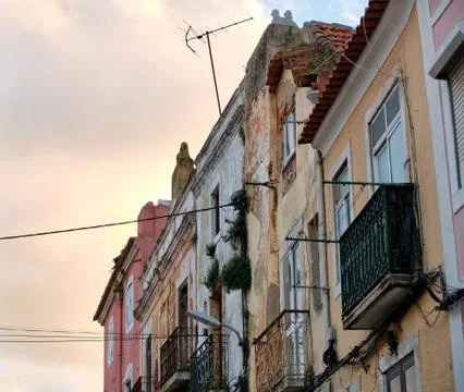 A colourful Old Town facade is dramatically lit by a sunset from behind Stock Photos