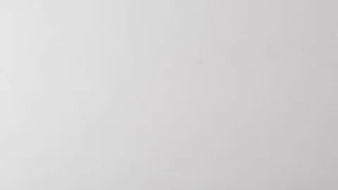 Colourful paperclips fall onto table in slow motion Stock Footage 117349457